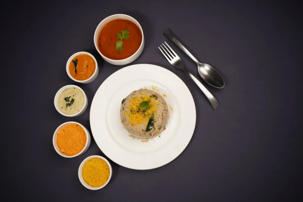 Delicious Indian Upma served with various chutneys and sambhar, perfect for food enthusiasts.
